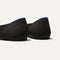 The Flat round toe shoe in Black Solid shown from the back view with the heel detail.