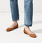 hover | The Flat round toe shoe in Fawn shown on-model at an angle.