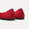 Close up of the heel of The Flat in Bright Red, with Rothy's signature blue halo. 