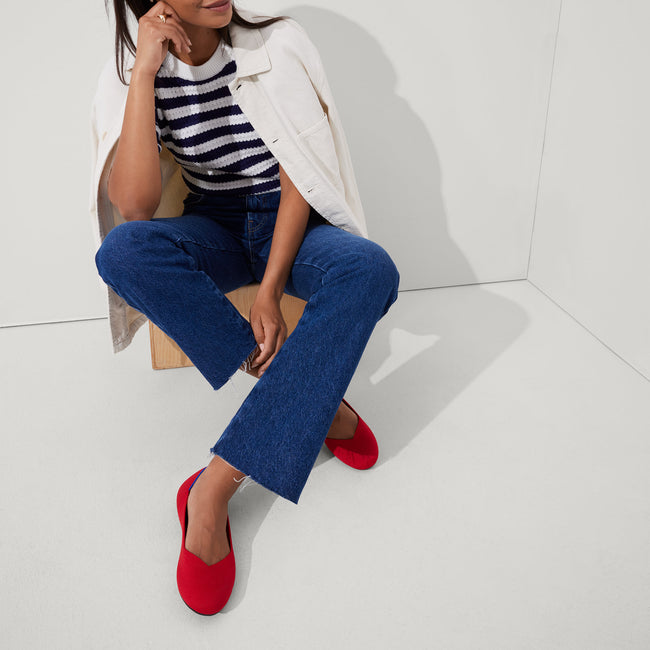 Alternate view of a model wearing The Flat in Bright Red.