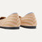 The Flat round toe shoe in Golden Hour shown from the back view with the heel detail.