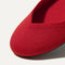 Close up of the rounded toe and v-shaped vamp of The Flat in Bright Red.