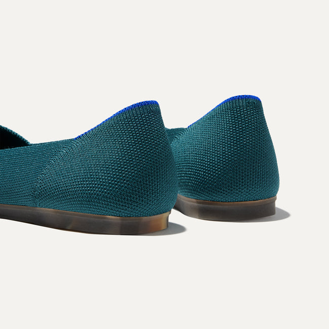 Close up of the heel of The Flat in Deep Emerald, with Rothy's signature blue halo.