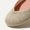 Close up of the rounded toe and v-shaped vamp of The Flat in Light Gold Metallic.