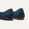 Close up of the heel of The Flat in Navy, with Rothy's signature blue halo. 