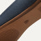 The sole of The Flat in Navy shown in diagonal view. 
