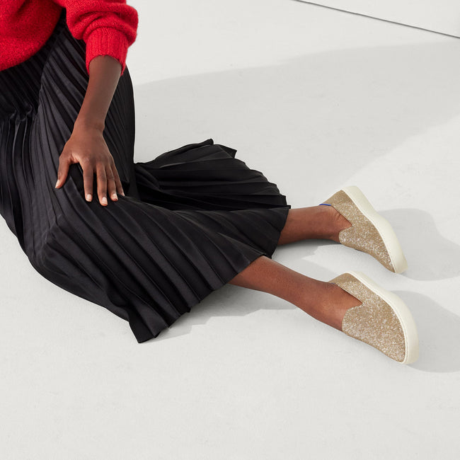hover | Model wearing The Original Slip On Sneaker in Gold Twill.