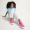 Alternate view of a model wearing The Kids Sneaker in Bubblegum.