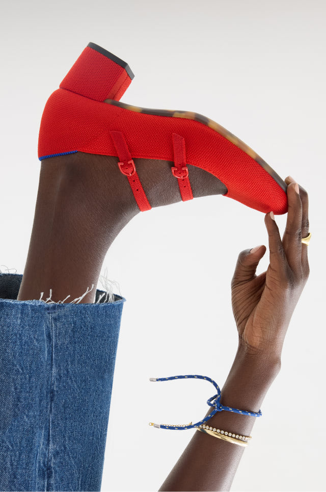 Close up shot of Model wearing The Double Buckle Mary Jane Heel in Bright Red.