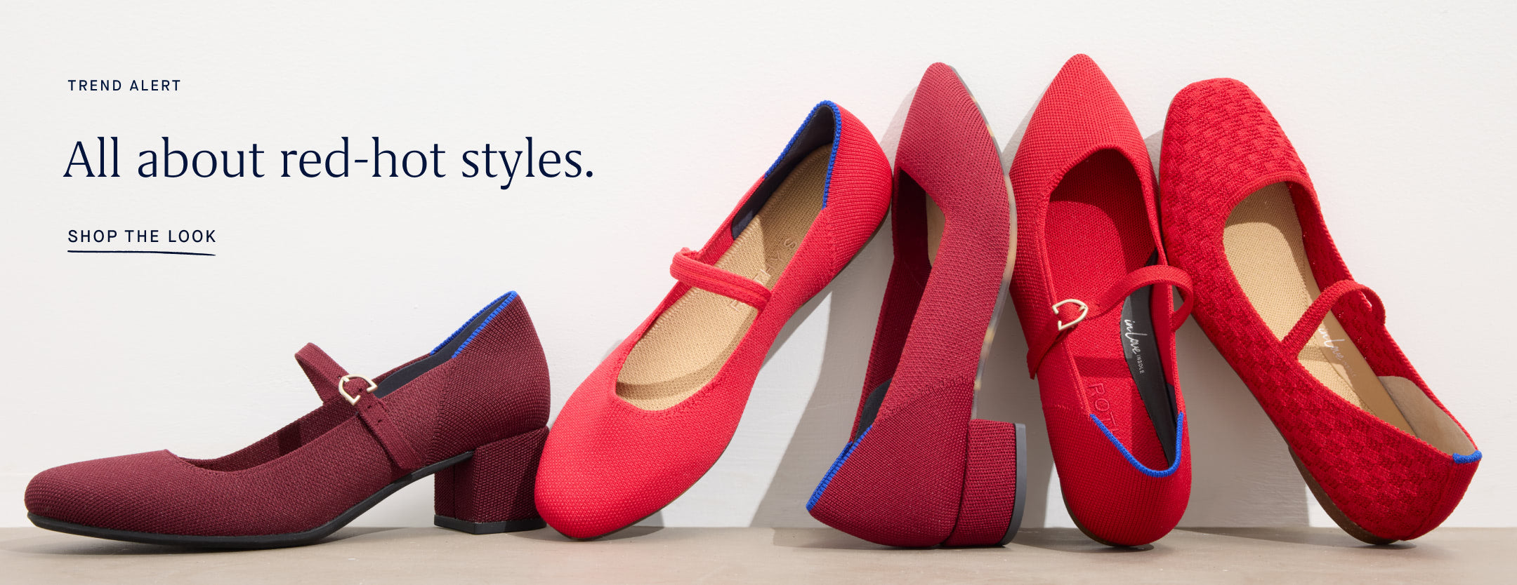 A stylish array of red footwear, including heeled and pointed Mary Janes, highlighting diverse shades of red.