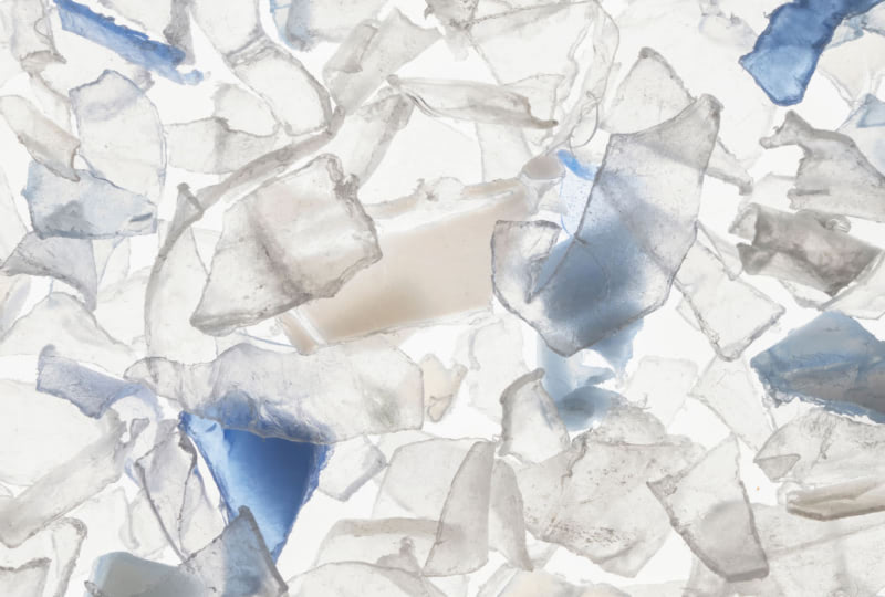 A closeup image of broken pieces of clear plastic.