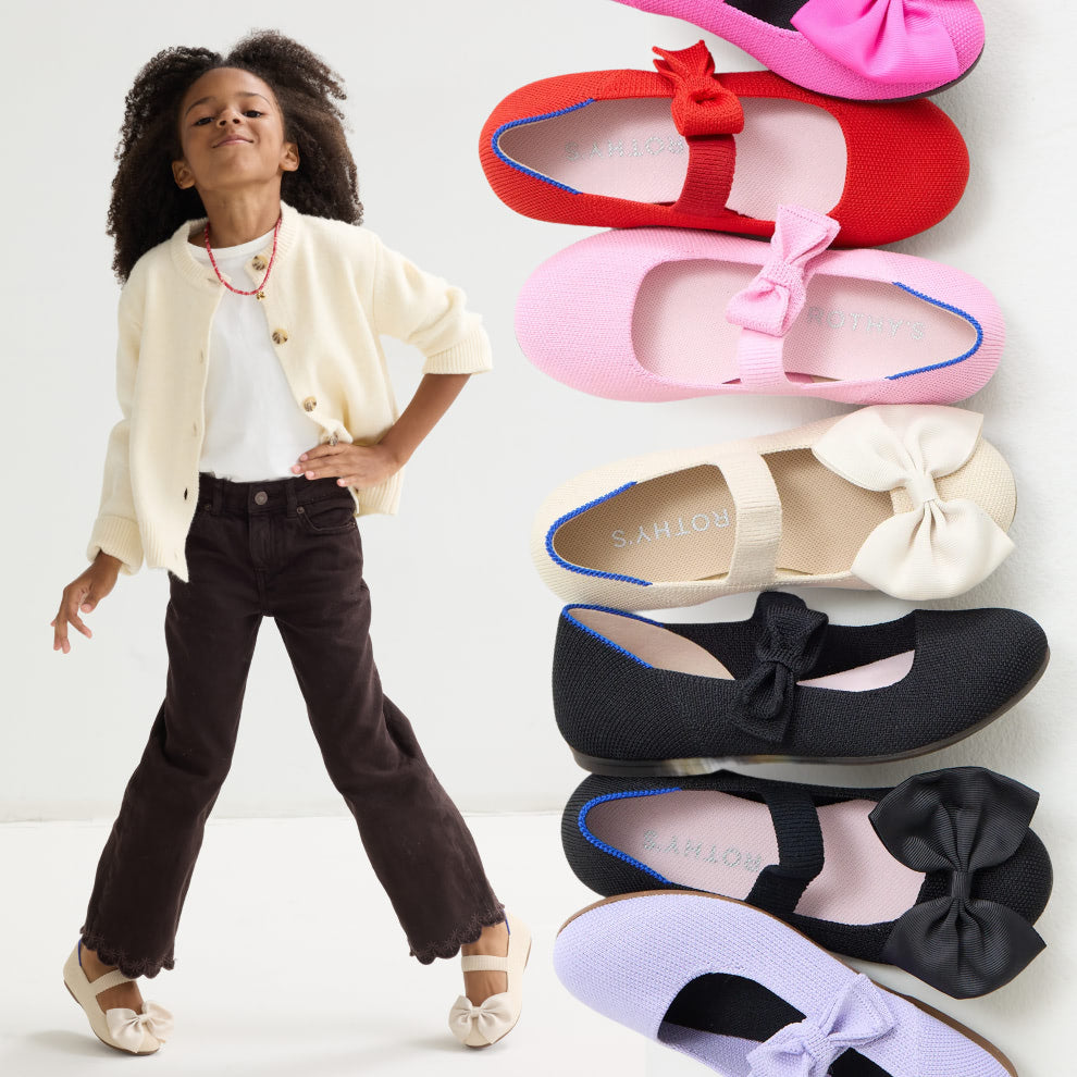 Child wearing The Kids Big Bow Mary Jane with a display of The Kids Big Bow Mary Jane in Black, Dragon Fruit, Conch.