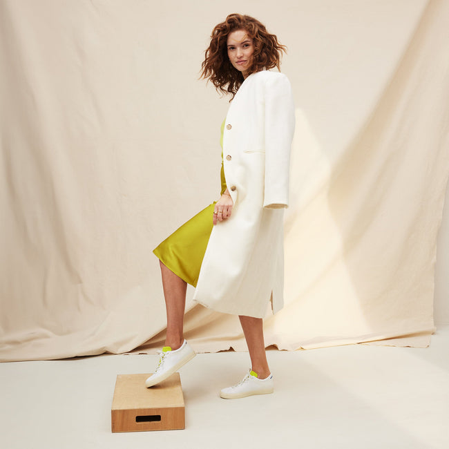 Alternate view of a model wearing The Lace Up Sneaker in Chartreuse. 