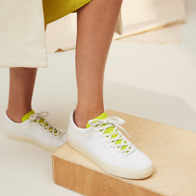 Model wearing The Lace Up Sneaker in Chartreuse. 