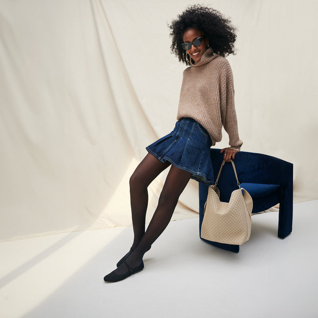 The Bucket Bag in Knot Brown shown worn differently on model. 