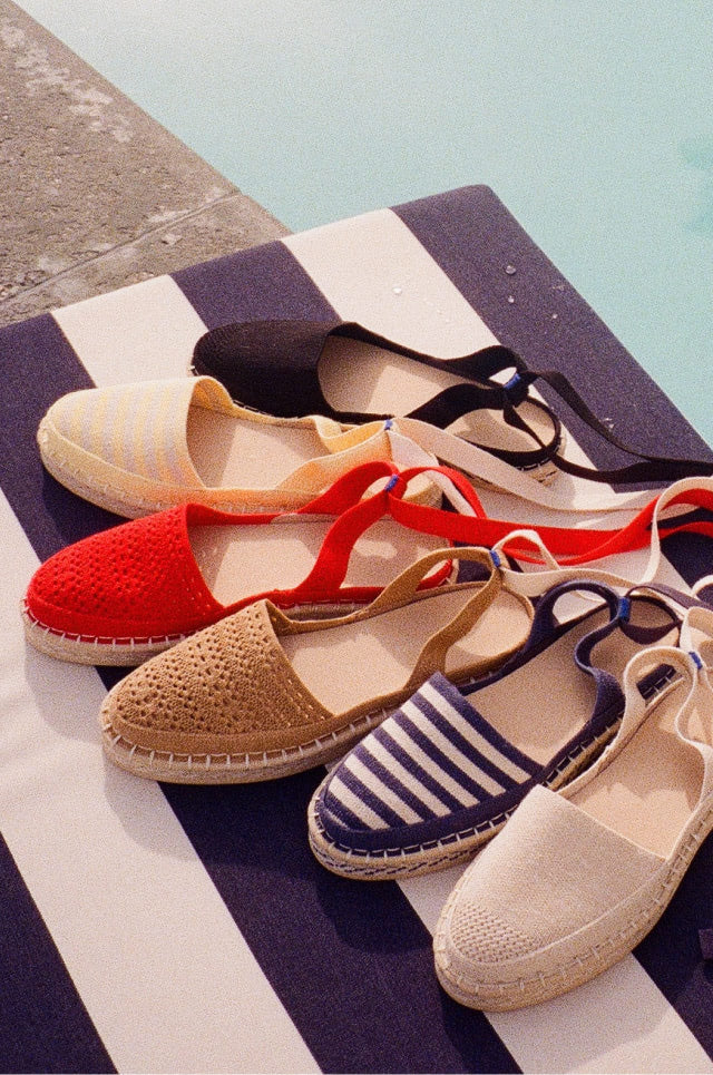 Collection shot of The D'Orsay Espadrille in Black, Sunshine Stripe, Deep Sea Stripe, Seashell, Camel Crochet, and Bright Red Crochet.