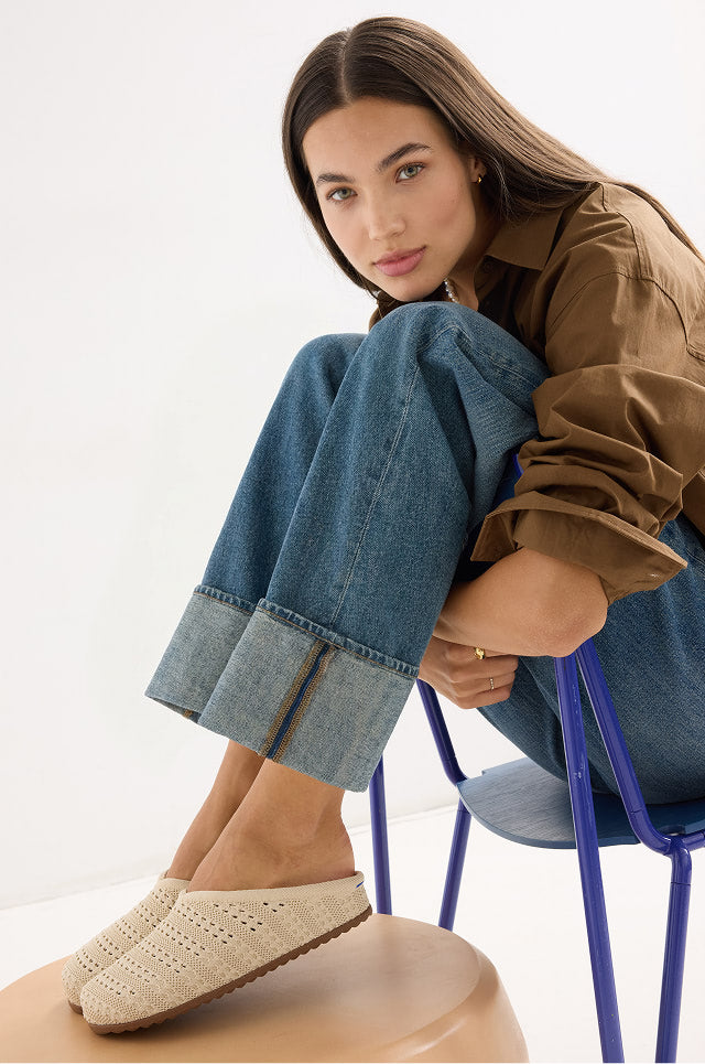 Woman sitting on a chair wearing The Casual Clog	Powder Crochet.