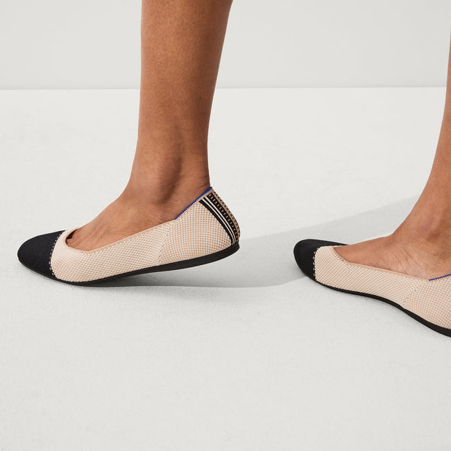 The Square toe flat shoe in Tuxedo shown on-model at an angle.