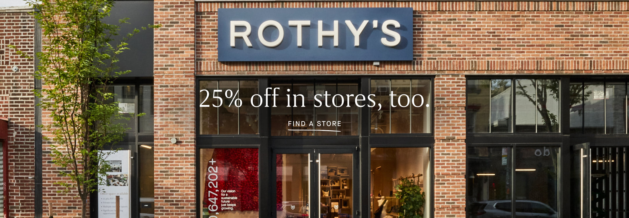 Rothy's store front with promotional sign on a brick building