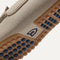 Close up of the outsoles of The Driving Loafer in Barley, with raised nub details and the Rothy's signet on the base of the shoe. 