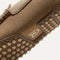 Close up of the outsoles of The Driving Loafer in Canyon Brown, with raised nub details and the Rothy's signet on the base of the shoe. 