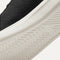 Close up of the outsoles of The RS01 Sneaker in Black, with raised grooves for added traction.