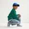 Alternate view of a model wearing The Kids Strap Sneaker in Berry Blue. 