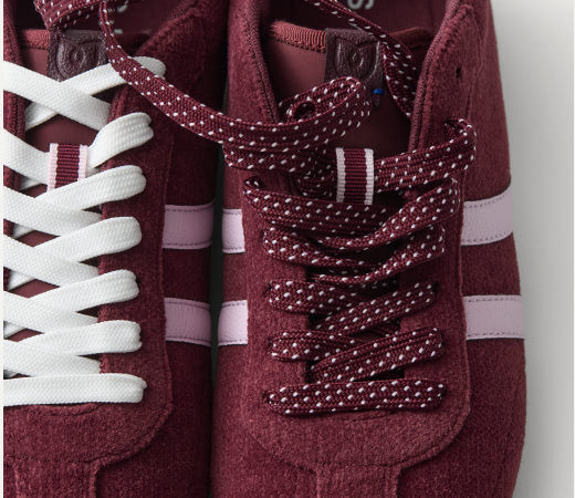 Close-up shot of The Ivy Sneaker	in ReVelvet Syrah focusing on the laces.