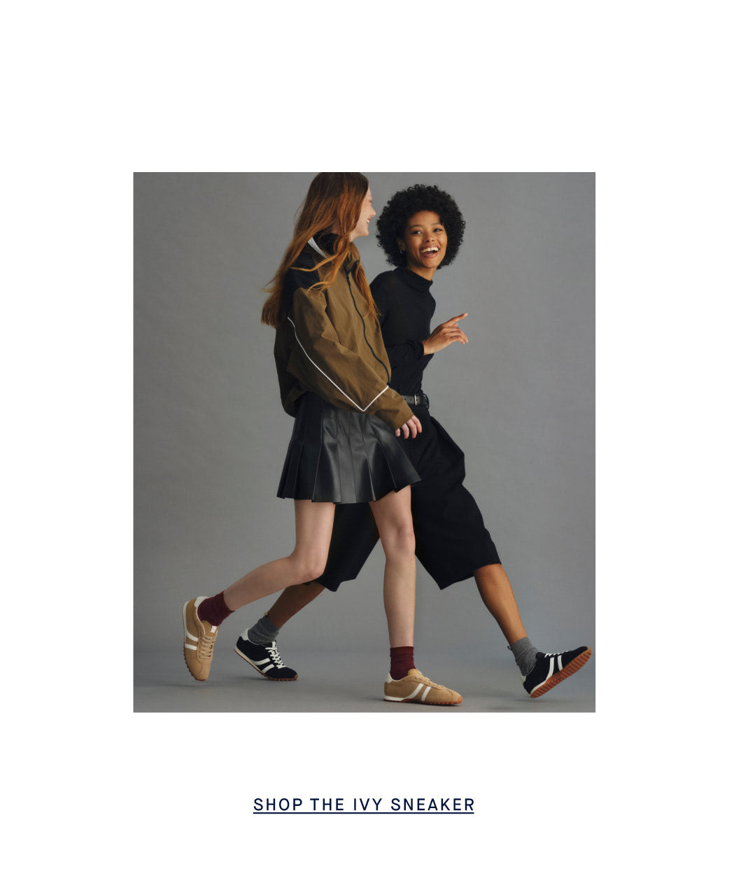 Two models walking side-by-side in a studio setting, showcasing the 'Ivy Sneaker' 