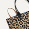 Close up of the handles and key leash detail of The Lightweight Tote in Desert Cat. 