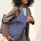 hover | Model holding The Wristlet in Indigo Cat.