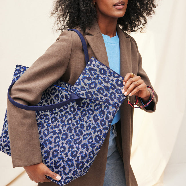 Model holding The Lightweight Tote in Indigo Cat.