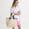 hover | Model holding The Lightweight Tote in Ivory Carnation.