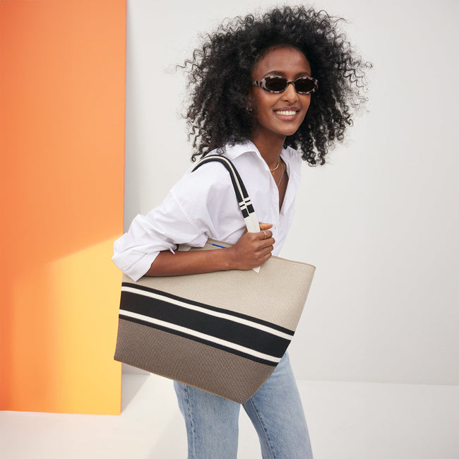 Model holding The Lightweight Tote in Jetset Black.