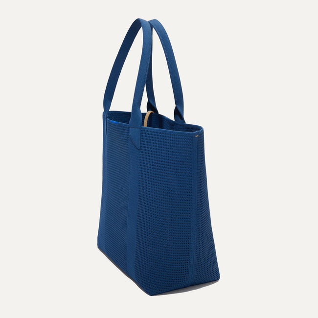 The Lightweight Tote in Ocean Blue shown in diagonal view.