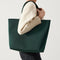 hover | Model holding The Lightweight Tote in Rainstorm Green.