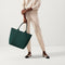 An alternate view of model holding The Lightweight Tote in Rainstorm Green.