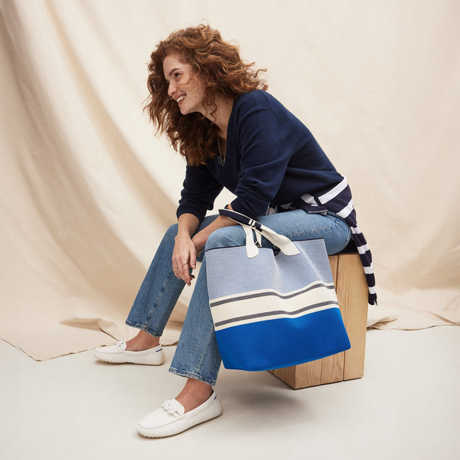 An alternate view of model holding The Lightweight Tote in Sailboat Blue.