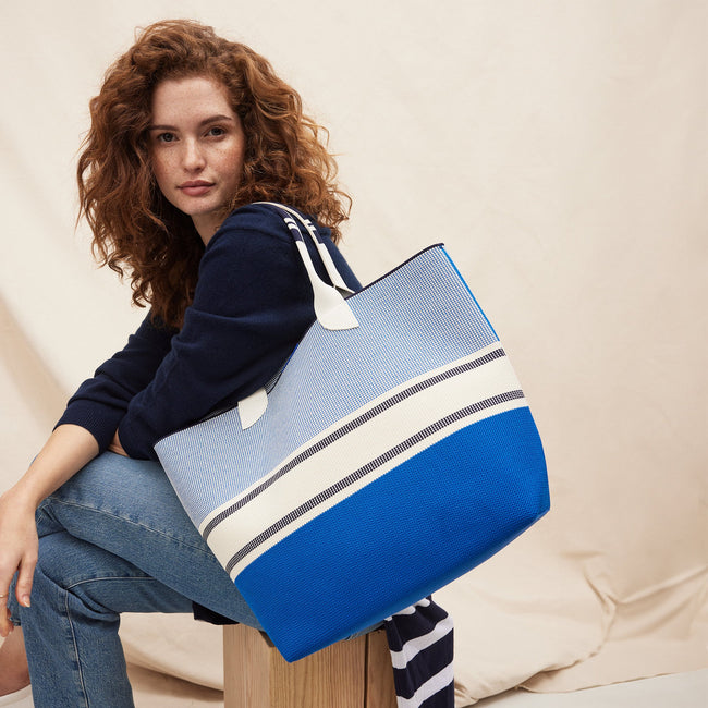 Model holding The Lightweight Tote in Sailboat Blue.