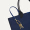 Close up of the handles and key leash detail of The Lightweight Tote in Sapphire and Onyx. 