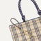 Close up of the handles and key leash detail of The Lightweight Tote in Spring Plaid. 