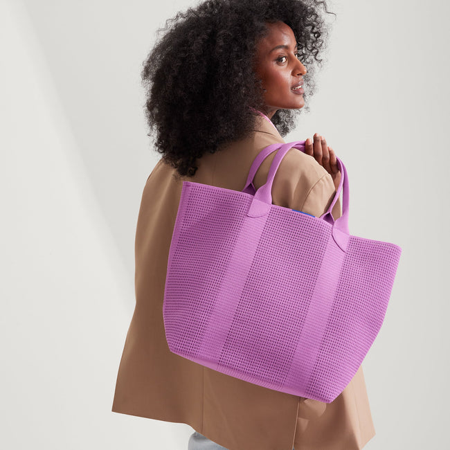 Model holding The Lightweight Tote in Summer Berry.