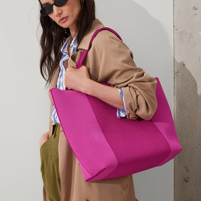 Model holding The Lightweight Tote in Tulip Pink Colorblock.