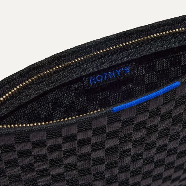 The Wristlet in Black Sand interior view with Rothy's halo detail.