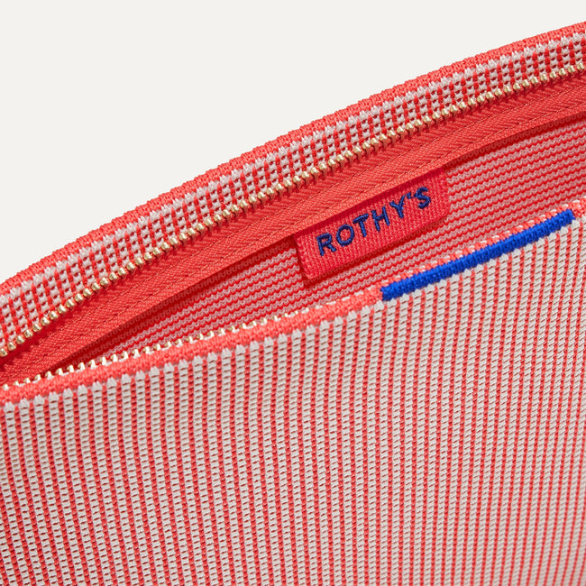 The Wristlet in Coral Grid interior view with Rothy's halo detail.