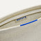 A closeup of The Wallet Wristlet in Diamond Metallic, focusing on the inner card slip.