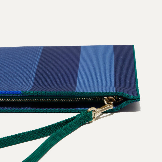 Close up of the zipper closure and wrist strap of The Wristlet in Ivy Rugby Stripe.