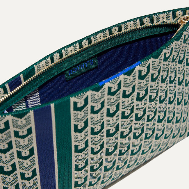 Close up of The Wristlet in Signature Green shown unzipped.