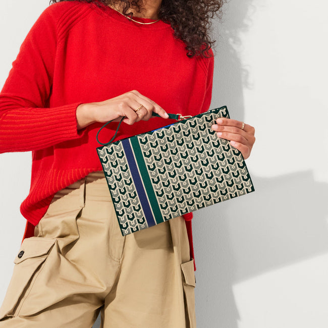 Model holding The Wristlet in Signature Green.