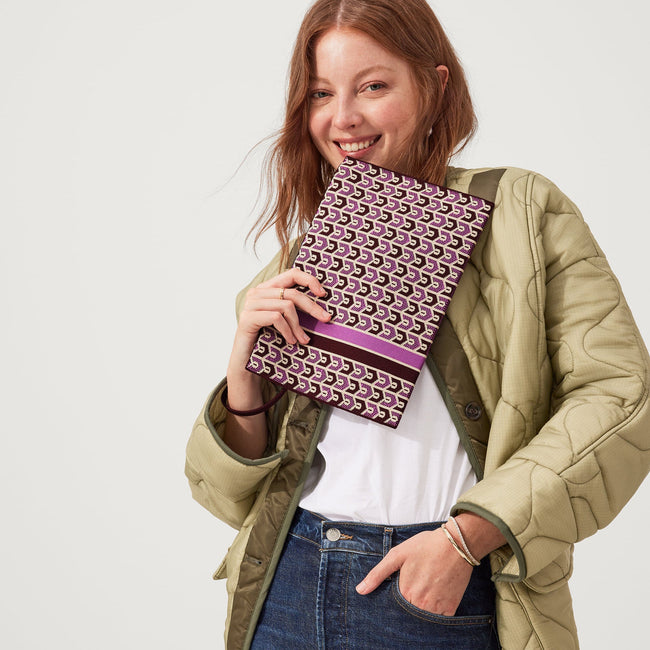 hover | Model holding The Wristlet in Signature Plum.